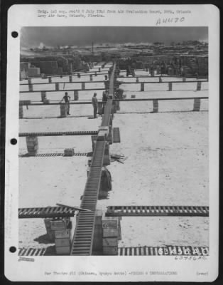 Thumbnail for Supplies > Shown Is A View Of The Usa Sobe Dept., 447Th Qm Depot Co. (Sup), Which Was A Pattern Of Many Of The Supply Areas In The Pacific.  Construction Of All Areas Was Usually Coral.  On These Surfaces Supplies Were Received And Separated On Roller As Seen, To Be