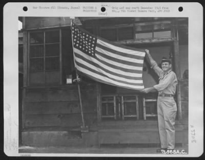 Thumbnail for General > John Howton Of Edinburg, Texas Holds The American Flag He Made For The Hanowa Prisoner Of War Camp #6 At Honshu, Japan From Drop Parachutes. 14 September 1945.