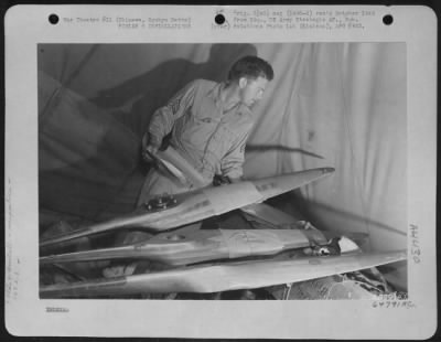 Thumbnail for Supplies > Clerk Of The 163Rd Liaison Squadron, 10Th Army, Checking Supply Of Propellers.  Okinawa, Ryukyu Retto.