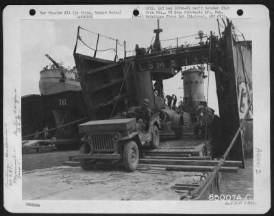 Thumbnail for General > Equipment Of The 318Th Fighter Group Rolls Ashore On Ie Shima, Ryukyu Retto From An Lsm (Landing Ships, Mechanized).  Driving Jeep Is Cpl. Giles N. Ragsdale, Malden, Missouri, 19Th Fighter Squadron, 318Th Fighter Group.  29 April 1945.