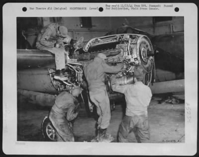 Thumbnail for Engines > A 9th Air force P-38 Lightning fighter-bomber undergoing repairs by mechanics at a base somewhere in Belgium. Working along hours and under adverse conditions, the ground crewmen play an important part in the air offensive against Germany.