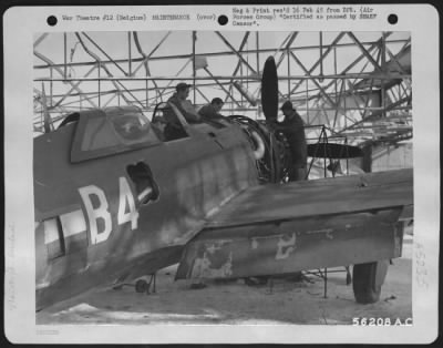 Thumbnail for Engines > Mechanics work on a Republic P-47 Thunderbolt inside a hangar blasted by Allied heavy bombers during the Luftwaffe occupation of the field. This is the seventh field used by the 365th Fighter-bomber group since June 28, 1944, the day advance elements