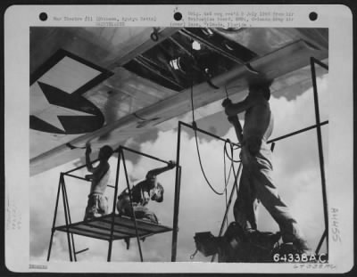 Thumbnail for General > Sheet Metal Workers Of The 480Th Service Sqdn, 59Th Service Group Repairing Flak Damage On The Wing Of A Boeing B-29 "Superfortress".  This B-29 Was Based At Guam, And After Making A Strike On Japan Was Forced Down By Flak Damage To The #4 Engine Which Cu