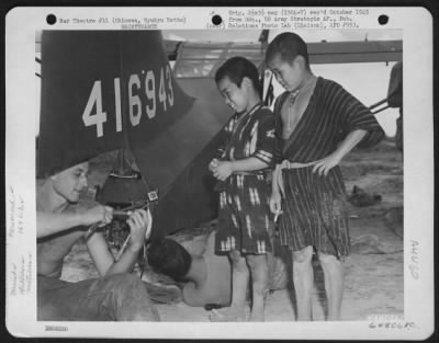 Thumbnail for General > Two Native Children Of Okinawa, Ryukyu Retto, Watch Sgt. Dudley Maddern, 3210 Avenue H, Brooklyn New York, Repair Tail Of Vultee L-5 'Sentinel'.  163Rd Liaison Squadron.