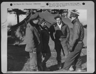 Thumbnail for General > BELGIUM--Talking over a mission in front of the captured German tents that are used for Operations and Orderly Room are 2nd Lt. Coleman F. Cody, assistant operations officer, 356 Tappan St., Brookline, Mass.; S/Sgt. Herbert Young, 136, 172nd St.