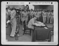 Fleet Admiral Chester W. Nimitz Signs For The United States During The Surrender Ceremonies On The U.S.S. Missouri In Tokyo Bay, August 31, 1945.  At The Microphone At The Left Is General Of The Army Douglas Macarthur. - Page 1