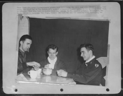 Thumbnail for General > Three Ninth Air force fighter-bomber pilots from Caliofrnia, who shot down five FW-190's among them during, the first day of von Rundstedt's counter offensive, compare notes in the squadron ready room in Belgium. They are, left to right: first man