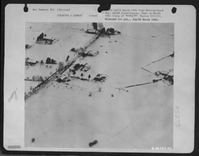 Thumbnail for General > This is how a Nazi road convoy (between St. Vith and Schonberg, Belgium) looks to a "dicing" 9th Air force tact recon. pilot. He files right through fire of three AA guns (smoke puffs at right).