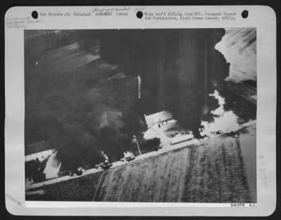 Thumbnail for General > On a highway in Belgium recently, 8th Air force fighter planes found a column of oil-tank trucks moving up to the german lines. Strafing at a low level, all the vehicles were set afire and one may be seen exploding at the right.