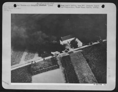 Thumbnail for General > 8th Air force fighter planes swept down to tree-top level and strafed a column of German oil tank trucks on a highway in Belgium during one of their many recent attacks on Nazi transport. Five of the vehicles may be seen burning fiercely here.