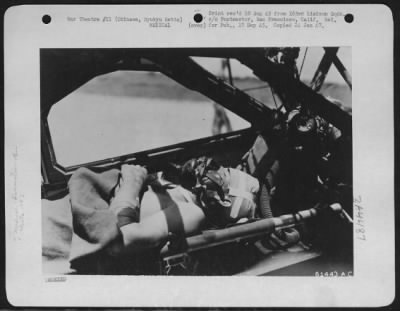 Thumbnail for Evacuation > A Marine, Wounded In Chest And Head, Awaits Air Evacuation By Aircraft Of 163Rd Liaison Squadron From Okinawa Front.  Marine Is Aided In Breathing By Aviator'S Oxygen Mask And Supply Bottle.  The Bottle, With Attached Hose And Mask, Is Fastened Behind Pil