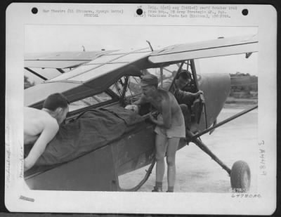 Thumbnail for Evacuation > Medics Removing Litter Patient From Vultee L-5 'Sentinel' As T/Sgt. Sylian H. Sharp, Pilot, From Duncan, Oklahoma, Looks On.  Evacuation Cases Were Flown To Field No. 10, Okinwaw Ryukyu Retto.