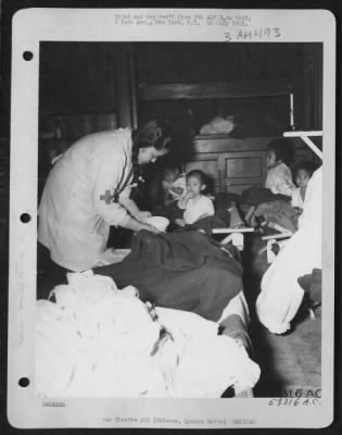 Thumbnail for Hospital Patients > A Native Nurse Feeding One Of The Patients At The Amg Hospital On Okinawa On 16 May 1945.