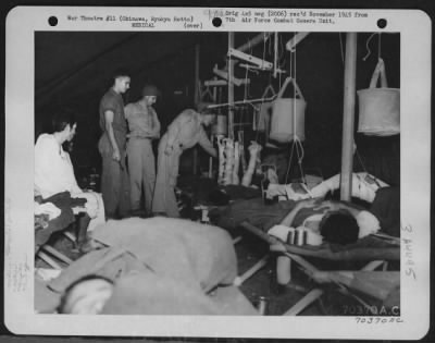 Thumbnail for Hospital Patients > Personnel Assigned To The American Military Government Medical Unit Check The Condition Of Patients In The Traction Ward At The Hospital On Okinawa, Ryukyu Retto.  15 June 1945.