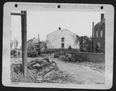 General > A German convoy, including American tanks & half-tracks captured during the counter-offensive, attempting a withdrawal to Houffalize was caught in the center of Noville, Belgium by 9th AF fighter-bombers and ground artillery, with results shown