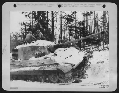 Thumbnail for General > Ninth Air force fighter-bombers in co-operation with ground artillery knocked out this Royal Tiger tank on the main road from Bastogne to Houffalize during recent fighting in the Belgian Bulge. The condition of trees in the background provides an