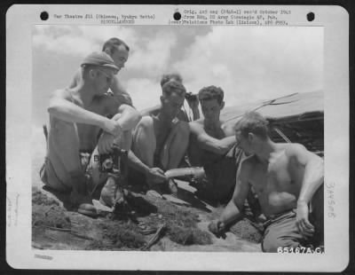 Thumbnail for General > Engineers Of The 807Th Engineer Aviation Battalion Examine A Piece Of Shrapnel That Hit Their Area During An Explosion Of An Ammunition Dump On Okinawa, Ryukyu Retto.  The Explosion Occurred A Mile And Half Away From Their Cam Area.