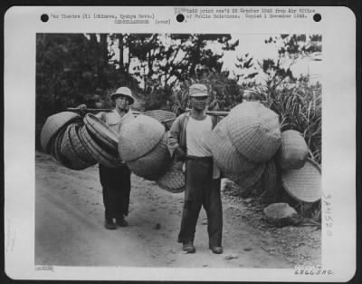 Thumbnail for General > And The Basket-Makers Are In Business - Baskets Of All Shapes And Sizes, And For Many Purposes, Seem To Be Woven Throughout The Island.  These Two Okinawans, With An Average Load, Were Photographed While Enroute To Market With Their Wares.  Okinawa, Ryuky