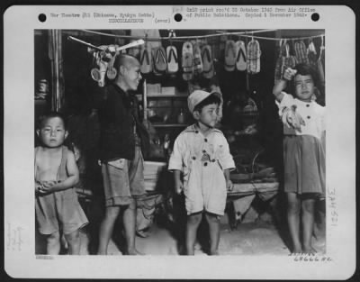 Thumbnail for General > All-Purpose Store In Shuri City - One Village In Okinawa Which Has Several Stores Open For Business Is Shuri City, Once The Capital Of Okinawa, Ryukyu Retto During The Golden Age.  Children Are Shown In Front Of One Of The All-Purpose Stores.  The Tall Bo