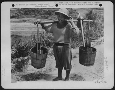 Thumbnail for General > Native Farmer Tips Sun Helmet In American Fashion - A Toothy Smile Is Given By This Native, Carrying Buckets Usually Filled With Fertilizer Or Water.  The Hat Is A Hand-Me-Down From The Military.  The Odd-Shaped Hoe Is Used For Many Purposes By Okinawan F