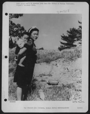 Thumbnail for General > Mother And Child - Okinawa Style - With Baby Strapped To Her Back In Oriental Fasion, This Okinawan Mother Stopped Briefly In The Field To Pose For The Air Force Photographer Before Gathering Potatoes In The Basket.  Okinawa, Ryukyu Retto.