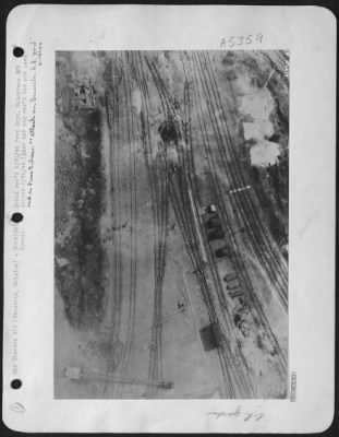 Brussels > Uprooted tracks and cars-Heavy damaged can be seen at the marshalling yards in Brussels, Belgium from the attack on 1 May 44 by U.S. 8th AAF heavies.