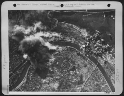 Liege > Smoke of varying colors from fires and explosions wings upward from the marshalling yards at Liege, Belgium on 25 May 44 as Boeing B-17 Flying ofrtresses of the U.S. 8th AAF concentrated their lethal load there. Fires were reported burning fiercely.