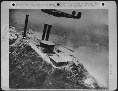 Koyagishima > A North American B-25 Bomber Of The 5Th Af Bomber Command Swoops Over An Oil Refinery On The Coast Of Koyagi Shima Off The Mainland Of Japan.  The Mitchells Left The Refinery A Total Wreck.  Note This Bomber Still Has Its Bomb Bay Doors Open And Fires Are