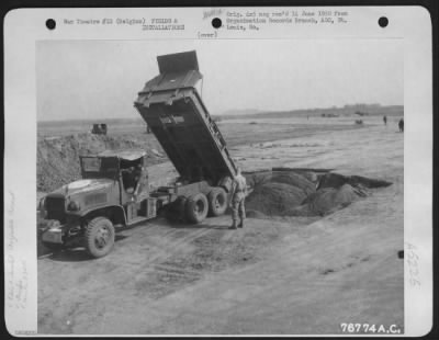 Thumbnail for General > A Dump Truck, Operated By Personnel Of The 834Th Engineer Aviation Battalion Empties Dirt Into A Bomb Crater During The Repair Of An Airfield At St. Trond, Belgium, 21 September 1944.