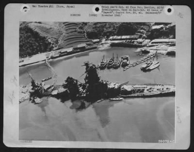 Kure > Japan - Hyuga, One Of The Two 30,000-Ton Battleships Modernized By The Japs In 1937, Now Lies Wallowing In The Mud Of Kure Naval Base, Riddled From Incessant Carrier Plane Strikes.