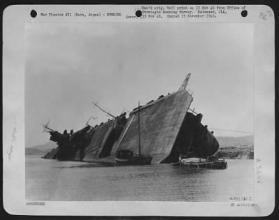 Kure > Japanese Aircraft Carrier Laying On Its Side Near A Small Village In Vicinity Of Kure, Japan.