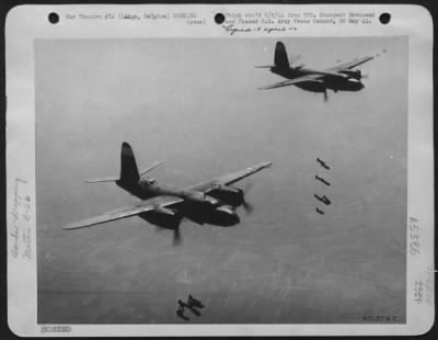 Thumbnail for Liege > Two Martin B-26 Marauder Bombers Of The Ninth Air Force, Drop Their Bombs On A Railroad Bridge Target, 10 Miles From The German Border At Liege, Belgium.  Observers Saw Large Explosions In The Target Area Indicating That Fuel Storage Tanks May Also Have B