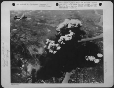 Thumbnail for Budapest > Heavy bombers of Maj. Gen. Nathan F. Twining's U.S. Army 15th Air force find their mark again, as a huge smoke column rising from oil refineries at Budapest, Hungary, casts a black shadow across the Danube and surrounding countryside.