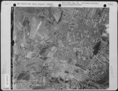 Thumbnail for Gyor > Bomb bursts cover the target area after planes of the 2nd Bomb Group, 96th Bomb Squadron dropped their lethal missiles on the Aircraft Factory at Gyor, Hungary, 9 August 1944.