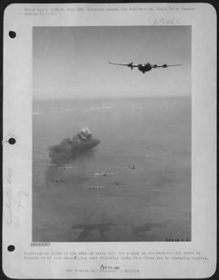 Thumbnail for Petfurdo > Consolidated B-24s of the 15th AF swing into the attack on the Petfurdo oil plant in Hungary on 14 June 44-Flying over billowing smoke from fires set by preceding bombers.