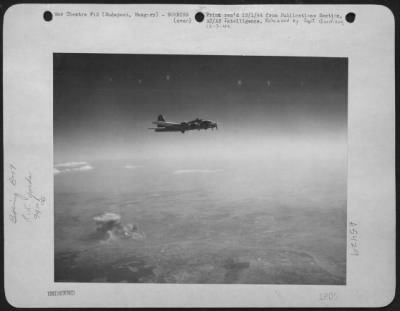 Thumbnail for Budapest > A Cloud Of Smoke Rises From The Railyards At Budapest, Hungary, As This Boeing B-17 "Flying Fortress" Of The 15Th Air Force Comes Off The Target.  Heavy Bombers Attacked This Target On 17 Sept. 44.