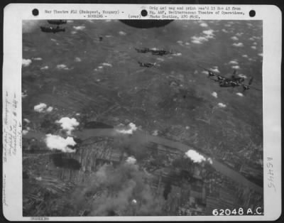 Thumbnail for Budapest > Bombing Of Duna Airdrome, Budapest, Hungary, By Consolidated B-24 "Liberators" Of The 485Th Bomb Group, 15Th Air Force, On 30 June 1944.  A Formation Of The "Liberators" Are Shown Over The Smoking Target.