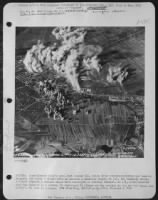 DURING: Consolidated B-24's have just bombed (C), which later reconnaissance showed heavily damaged, including 9 direct hits on machine & assembly shops. At (A), two assembly shops, 3 flight hangars & machine shops were destroyed or heavily damaged. - Page 1