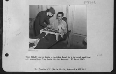 Thumbnail for General > The Flight Nurse Lends A Helping Hand To A Patient Awaiting Air Evacuation From Santa Maria, Azores.  23 Sept. 1945.