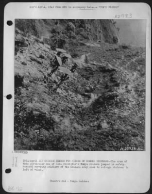 General > CHINESE SEARCH for PIECES OF BOMBER WRECKAGE--The crew of this particular one of Gen. Doolittle's Tokyo raiders jumped to safety. Parasol carrying soldiers of the Chinese Army seek to salvage whatever is left of value.