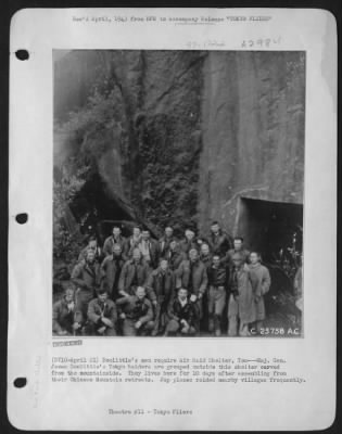 Thumbnail for General > Doolittle's men require Air Raid Shelter, Too---Maj. Gen. James Doolittle's Tokyo raiders are grouped outside this shelter carved from the mountainside. They lives here for 10 days after assembling from their Chinese Mountain retreats.