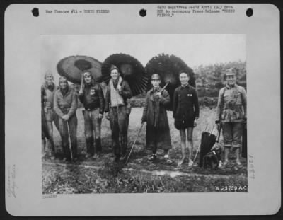 Thumbnail for General > FROM AERIAL UMBRELLA TO CHINESE PARASOLS. four members of Maj. Gen. James Doolittle's Raiding Party that dropped bombs on Tokyo April 18, 1942 exchange smiles with Chinese soldiers under picturesque parasols. Photo was taken during interim