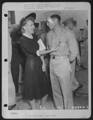 Thumbnail for Ceremonies & Decorations > Decoration of Tokyo Fliers at Bolling Field, D.C., by Lt. General Henry H. Arnold. Mrs Hilger admires medal which has been presented to her husband, Major John A Hilger. 27 June 1942.