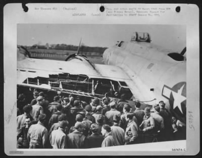 Thumbnail for Battle Damage > SLIGHT TEAR--Men of a First Air Division base view a ripped of a Boeing B-17 Flying ofrtress which managed to return safely after being attacked by jet-propelled Messerschmitt 262's on a recent Berlin air attack. The aircraft was piloted by 1st