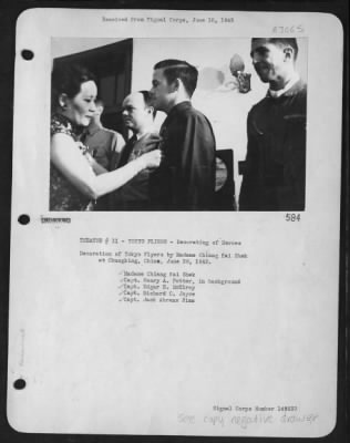 Ceremonies & Decorations > Decoration Of Tokyo Flyers By Madame Chiang Kai Shek At Chungking, China, June 29, 1942. Madame Chiang Kai Shek.  Capt. Henery A. Potter, In Background,  Capt. Edgar E. Mcelroy, Capt. Richard O. Joyce, Capt. Jack Ahren Sims.