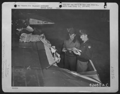 Thumbnail for Battle Damage > Lts. Barron And Powers Inspect Damaged Inflicted Upon A Boeing B-17 "Flying Fortress" Of The 493Rd Bomb Group, During A Bombing Mission Over Enemy Installations.  England, 31 March 1945.