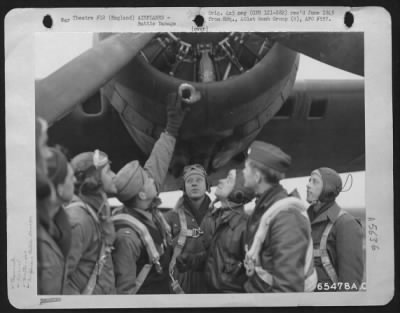 Battle Damage > Lt. Schotts And Crew Of The 401St Bomb Group Examine Shell Hole In Engine Nacelle Of Their Boeing B-17 "Flying Fortress".  England 1 Jan 44.