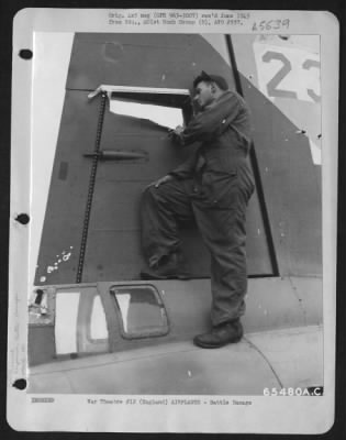 Battle Damage > Cpl. L.P. Moga Examines Damage To The Tail Section Of A Boeing B-17 "Flying Fortress" Of The 401St Bomb Group, England, 25 August 1945.