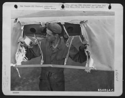 Thumbnail for Battle Damage > Sgt. R.H. Hampton Examines Battle Damage To A Boeing B-17 "Flying Fortress" Of The 401St Bomb Group At An 8Th Air Force Base In England, 29 May 1944.