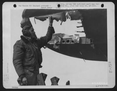 Thumbnail for Battle Damage > Lt. W.G. Mckenny Examines Hole In The Wing Of His Boeing B-17 "Flying Fortress" Of The 401St Bomb Group, England, 19 March 1945.